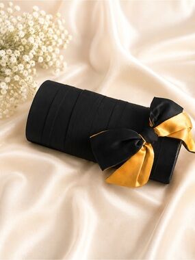 Elegant Black Clutch with Gold Bow Accent